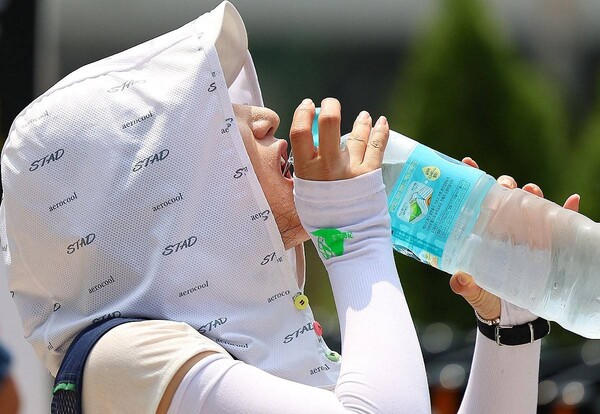 29일 서울 종로구 국정기획위원회 앞에서 열린 민주노총 건설노조 폭염 실태 기자회견에서 참가자가 물을 마시고 있다. /연합