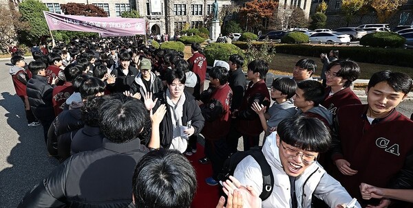 2026학년도 대학수학능력시험(수능)을 하루 앞둔 12일 서울 종로구 중앙고등학교에서 열린 수능 장행식에서 고3 수험생들이 선생님과 후배들의 응원을 받으며 학교를 나서고 있다. /연합